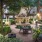 beautiful outdoor gathering area with tables, chairs and fireplace