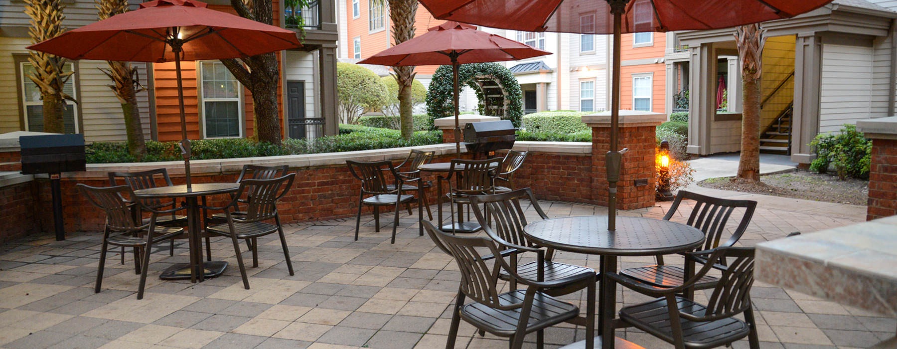 umbrella shaded tables and chairs in grilling area